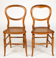 Lot 2004 - A pair of stained beech balloon-back bedroom...