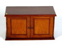 Lot 2024 - A small mahogany table cabinet with a pair of...