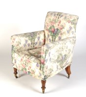 Lot 2043 - An easy chair with loose floral covers, raised...