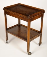 Lot 2045 - An oak two-tier tea trolley/card table with...