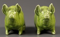Lot 445 - Wemyss: two green glazed pigs, impressed mark '...