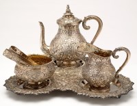 Lot 715 - An Indian embossed white metal tea service,...