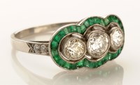 Lot 767 - A diamond and emerald ring, the three...