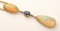 Lot 773 - An opal and sapphire drop pendant, the...