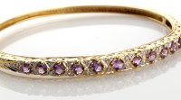 Lot 787 - A 9ct gold, amethyst and diamond bangle, half...