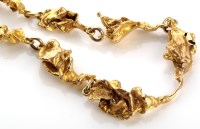 Lot 792 - A 9ct gold nugget pattern necklace, 36cms long,...