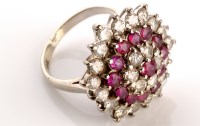 Lot 803 - A ruby and diamond cluster ring, made up of...