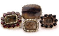 Lot 808 - Three mourning brooches, one set with red...