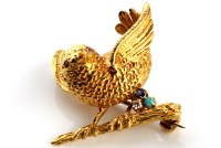 Lot 821 - An 18ct gold bird pattern brooch with ruby set...