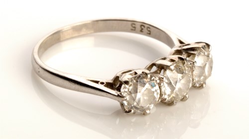 Lot 823 - A three stone diamond ring, the central stone...