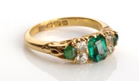 Lot 824 - An emerald and diamond ring, the three...