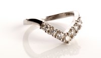 Lot 828 - A diamond wishbone pattern ring, set with...