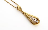 Lot 831 - A diamond and yellow metal drop pendant of...