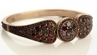 Lot 834 - A 19th Century garnet set bangle, set...