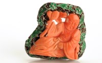 Lot 835 - A Chinese carved coral brooch, the central...