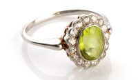 Lot 841 - A peridot and diamond cluster ring, the...