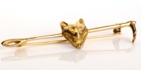 Lot 844 - A 9ct. gold fox and riding crop pattern brooch,...