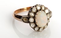 Lot 854 - An opal and diamond cluster ring, the central...