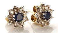 Lot 861 - A pair of sapphire and diamond cluster...