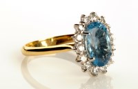 Lot 868 - An aquamarine and diamond cluster ring, the...