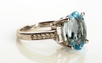 Lot 869 - An aquamarine and diamond ring, the oval cut...