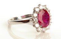 Lot 872 - A ruby and diamond cluster ring, the central...