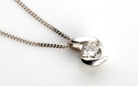 Lot 875 - A single stone diamond drop pendant, in 9ct....