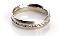 Lot 884 - A platinum and diamond set eternity ring, the...