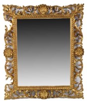 Lot 1068 - An ornate gilt Florentine frame wall mirror...