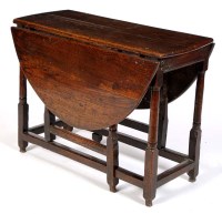 Lot 1079 - An early 18th Century oak drop-leaf gateleg...