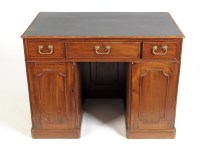 Lot 1092 - A late George III mahogany kneehole desk, with...