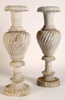 Lot 1133 - Two carved stone garden urns, decorated with...