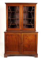 Lot 1146 - A Georgian mahogany bookcase on cupboard, with...