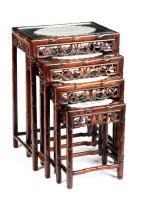 Lot 1173 - A nest of four Oriental hardwood tuck-away...