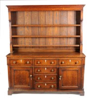 Lot 1201 - A Georgian oak dresser with three-tier open...