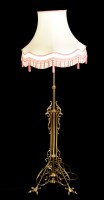 Lot 1204 - An ornate brass standard lamp with scrolling...