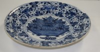 Lot 377 - A blue and white Delft charger, with central...