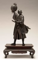 Lot 448 - A bronze figure of a Samurai, holding a...