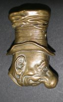 Lot 594 - A Victorian brass vesta modelled as Ali Sloper,...