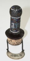 Lot 657 - An enamelled white metal stopper, probably...