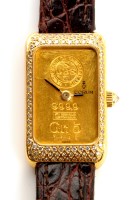 Lot 703 - A Corum 18ct. gold and diamond set cased...