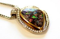 Lot 730 - A black opal and diamond pendant, the opal...