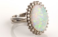 Lot 751 - An opal and diamond cluster ring, the oval...