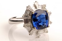 Lot 759 - A sapphire and diamond ring, the central...