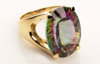 Lot 763 - A rainbow topaz ring, the oval facet cut stone...