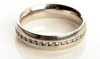 Lot 770 - A platinum and diamond set eternity ring, the...