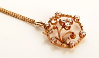 Lot 772 - A diamond set pendant of openwork scroll...