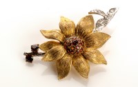 Lot 776 - A floral pattern brooch set with garnets and...