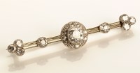 Lot 781 - A diamond set bar brooch, centring a diamond...