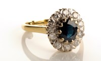 Lot 787 - A sapphire and diamond cluster ring, the...